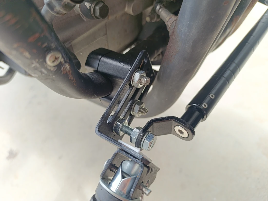 Close-up of the mounting blocks, slotted bracket, bolts and cross brace for the forward footpeg