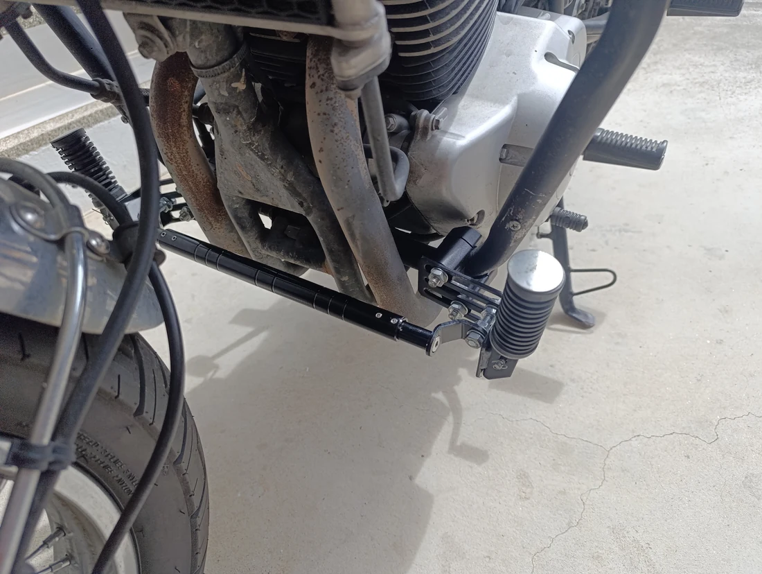 The forward footpegs folded upward on the GPX, with the cross brace visible ahead of the engine
