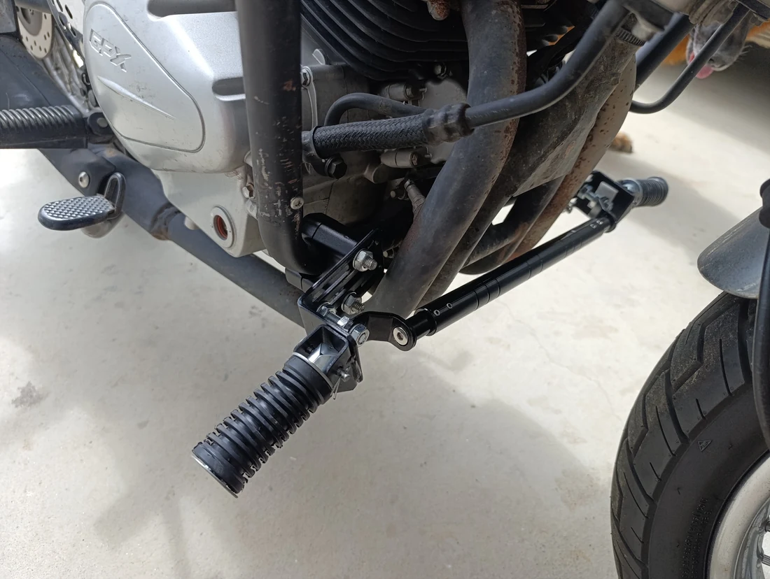 Right-side view of the extra forward footpeg, cross brace and original brake pedal on the GPX